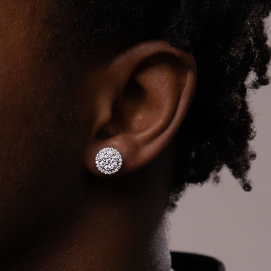 Big moissanite stud earrings with VVS iced-out round and square stones in white gold and 14K gold finishes.